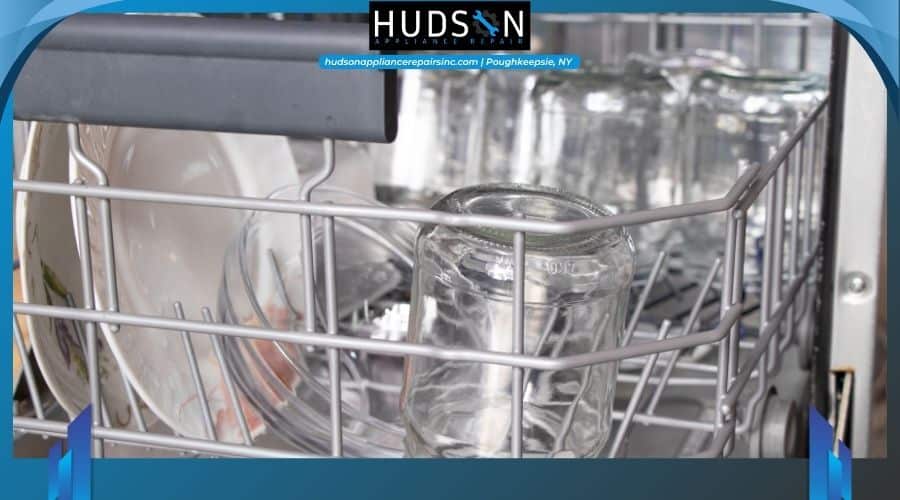 Close up of water droplets remaining on clean drinking glasses inside a dishwasher tub.