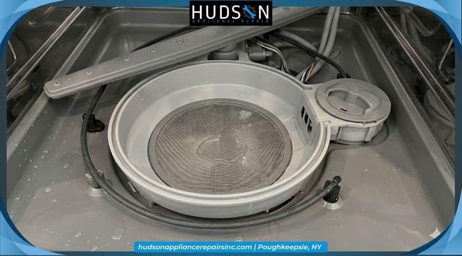 The bottom sump basin area of a dishwasher where the water collects.