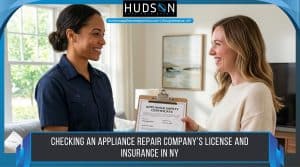 Appliance repair technician showing a homeowner a certificate during a home visit in New York